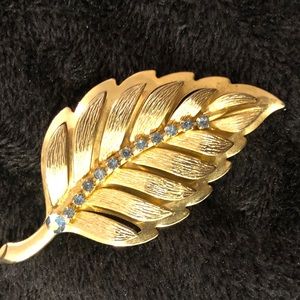 Gold tone leaf with light blue rhinestones brooch